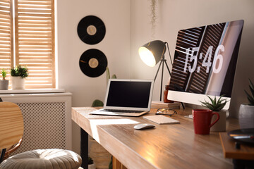 Wall Mural - Modern computer and laptop on wooden desk in room. Interior design