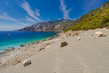 Wall Mural - Sand dunes beneath high mountains east of Agia Roumeli on the south coast of the Greek island of Crete