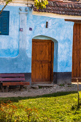 Sticker - Vertical shot of the picturesque village Viscri in Romania with painted traditional old door