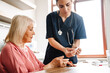 © Drobot Dean - A doctor showing a results of the measuring blood glucose level to her elderly patient in the room