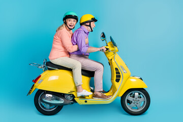 Poster - Profile side view of attractive cheerful amazed couple riding bike having fun isolated over bright blue color background