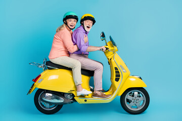 Wall Mural - Full size profile side photo of happy cheerful old couple ride bike journey isolated on pastel blue color background