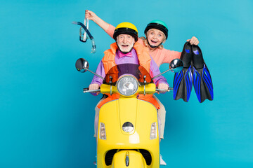 Sticker - Photo of happy amazed grey haired retired pensioner couple wear helmet hold diver equipment biker isolated on blue color background