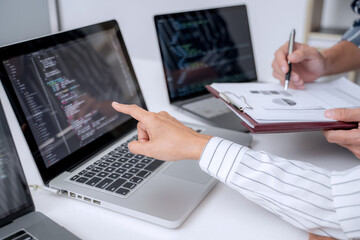 Wall Mural - programmer writing program code with two monitors and working on a new software or hacker programmin