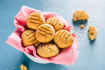 Wall Mural - cookies in a bowl on a blue background. homemade baking. copy space