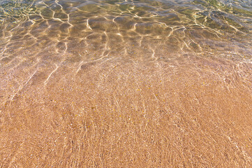 Sun glare on blue water at sea and on a sandy day on a sunny day