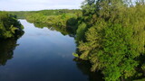 Fototapeta Natura - Aerial drone view flight over mirror smooth surface of river and trees