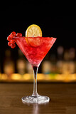 Fototapeta  - Closeup glass of cosmopolitan cocktail decorated with orange