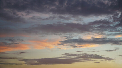 Wall Mural - dark, light clouds and blue sky at sunset