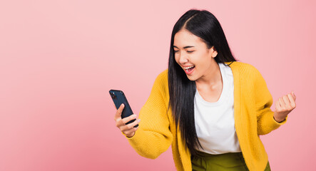 Wall Mural - woman teen smiling excited   using mobile phone say yes!