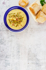 Wall Mural - Homemade vegetable soup with bread in blue plate.