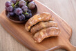 Sausage and grapes on cutting board