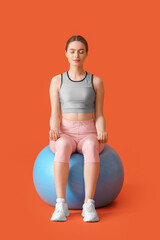 Sticker - Sporty young woman with fitball doing yoga on color background