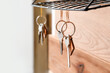 © Pixel-Shot - Key holder hanging on wooden wall, closeup