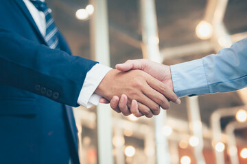 Business shaking hands, finishing up meeting. Successful businessmen handshaking after good deal.