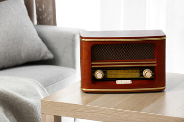 Wall Mural - Retro radio receiver on table in interior of room, closeup