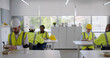 © TommyStockProject - Group of young industrial workers eating takeaway lunch at modern office canteen