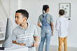 © Seventyfour - Waist up portrait of African-American boy looking at sculptures in modern art gallery, copy space