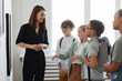 © Seventyfour - Diverse group of children listening to female tour guide while visiting modern art gallery, copy space