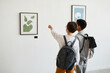 © Seventyfour - Minimal back view of two schoolboys looking at paintings in modern art gallery, copy space