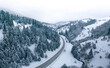 © maykal - Mountain road forest winter view from drone