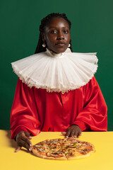 Wall Mural - One African young woman in bright red vintage dress with big white collar posing isolated on green background. Concept of comparison of eras, fashion, humor, ad.