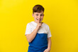 © luismolinero - Little redhead boy isolated on yellow background showing a sign of silence gesture putting finger in mouth