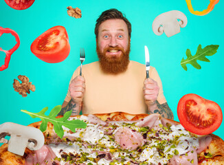 Wall Mural - Man with beard and tattoos is ready to eat a big pizza