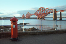 A Red Vintage British Post Box In Front Of The Iconic Forth Rail Bridge In South Queensferry, Scotland