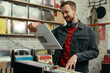 © New Africa - Young man with vinyl record in store