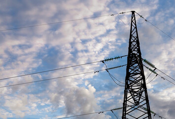 Silhouette of an electric tower. Electricity generation. High voltage post. High voltage tower on a background of blue sky.