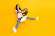 Full length body size view of lovely cheerful girl sitting holding steering wheel having fun isolated over bright yellow color background