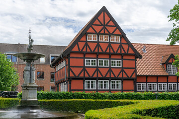 Canvas Print - historic red half-timbered house and the Kayerod fountain in the old town city center of Aalborg