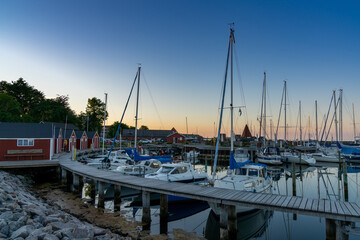 Poster - the picturesque small marina at Lundeborg with many sailboats and colorful hosues at sunset