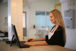 © FotoArtist - Smiling woman using laptop in work place for small businesses looking to engage audiences and scale content creation can adopt new marketing technology in workspace. Freelancer concept.