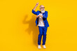 Full length body size view of nice attractive imposing cheerful man dancing having fun isolated over bright yellow color background