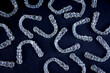 © Viktorua - Transparent invisalign retainers brackets pattern on black background. Dental invisible orthodontic care