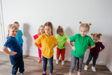 Group of children doing gymnastics in kindergarten or daycare