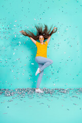 Poster - Vertical full length photo of cool young lady jump with sparkles wear eyewear yellow t-shirt jeans isolated on teal color background