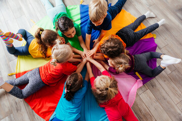 Wall Mural - Happy kids laying on a floor in circle