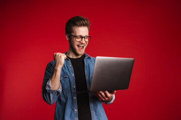 Happy smiling young man in casual clothes standing