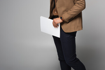 Wall Mural - Cropped view of businessman holding documents isolated on grey