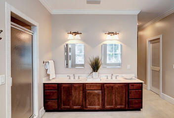 large bathroom with double sinks and separate shower.