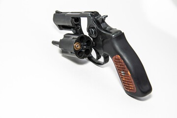 Russian Roulette is a revolver with one cartridge in the drum. Isolated on a white background. Close-up