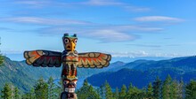 Totem Pole Towers Over Scenic Wilderness And Ocean