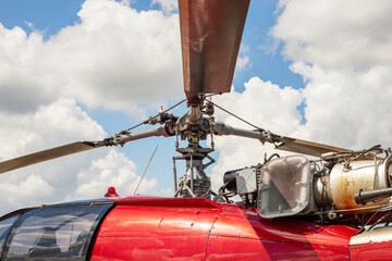 Wall Mural - Fragment of a helicopter. Helicopter propeller against a cloudy sky. Helicopter propeller. Part of copter rotor