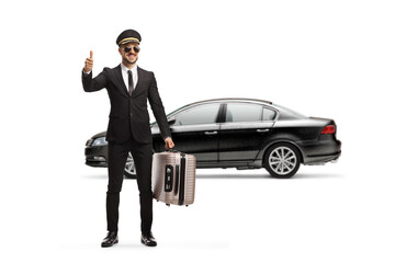 Poster - Full length portrait of a chauffeur carrying a suitcase and gesturing a thumb up sign