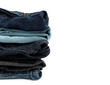 © Kitti bowornphatnon - Close up of Jeans stacked on background with empty space