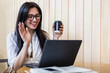© kostikovanata - Happy business female waving hand talking online video call use laptop sitting at table in cafe