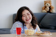 © Bangkok Click Studio - Happiness of Asian young sexy confidence smart beautiful long black hair oversized fat female model sit relax smiling enjoying food snack and drink on table in blurred foreground and background